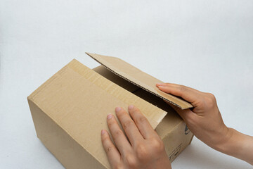 Unboxing the courier box with a cutter knife