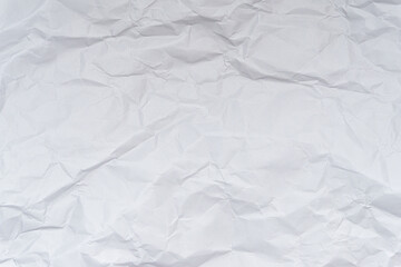 A mess of crumpled paper trash on a black background