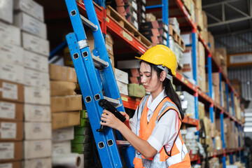 Warehouse worker checking the quantity of storage products on the shelf  in the warehouse.,...