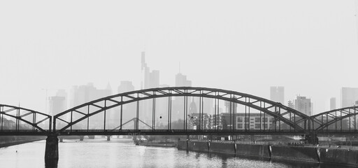 bridge over the river in front of the city skyline