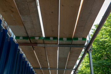 scaffolding with wooden planks, deck with wooden planks of the walkway seen from below, canopy,...