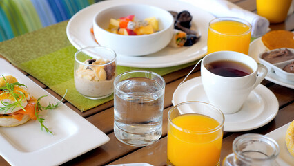 Served breakfast food in hotel restaurant. Buffet service. Tasty morning food in luxury modern resort. Fresh croissant, orange juice and english tea on cafe table.