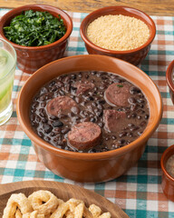 Typical brazilian feijoada with rice, caipirinha, farofa and cracklings