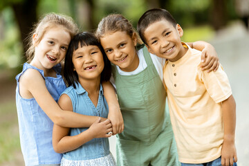 Group of asian and caucasian kids having fun in the park