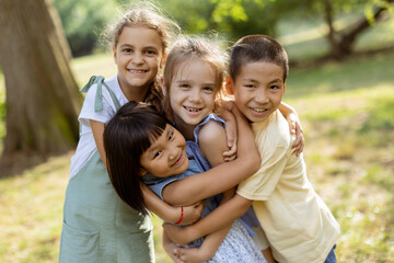 Group of asian and caucasian kids having fun in the park