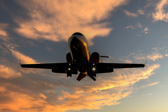 Learjet business aircraft on loading approach to airport through sunset over southern Germany. 