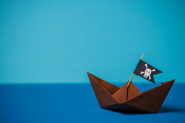 pirate paper boat on blue water