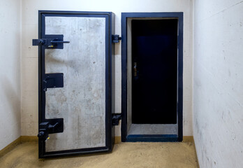 armored door of a public nuclear fallout shelter in an apartment building in Switzerland - obrazy, fototapety, plakaty
