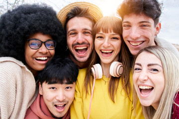 Portrait of Cheerful group of friends taking smiling selfie. Group of young students having fun together outdoors at university campus.