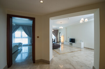 Cozy studio apartment design with bedroom and living space. Hotel room panoramic window, double bed, sofa and coffee table. Urban apartment concept