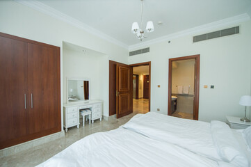 Cozy studio apartment design with bedroom and living space. Hotel room panoramic window, double bed, sofa and coffee table. Urban apartment concept