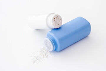 Skin care with talcum powder in container. Spilled white powder