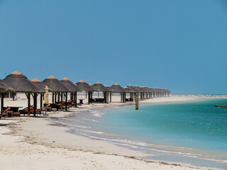 beach with umbrellas and chairs