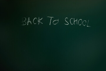 Back to school text drawing by chalk in blackboard