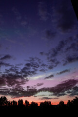 fiery orange and purple sky evening beauty and Clouds at sunset , dawn, the rays of the sun break through the clouds.