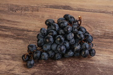 Purple grape branch over background