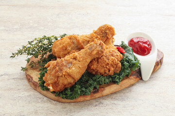 Fried chicken drumsticks with tomato sauce