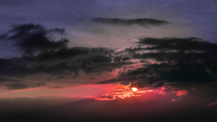 fiery orange and purple sky evening beauty and Clouds at sunset , dawn, the rays of the sun break through the clouds.
