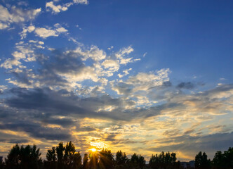 fiery orange and purple sky evening beauty and Clouds at sunset , dawn, the rays of the sun break through the clouds.
