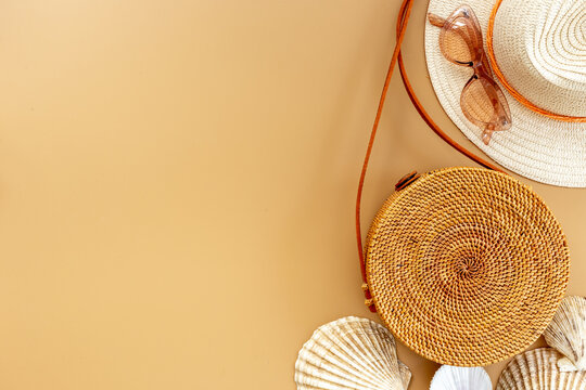 Beach vacation background - flatlay with straw hat and rattan bag