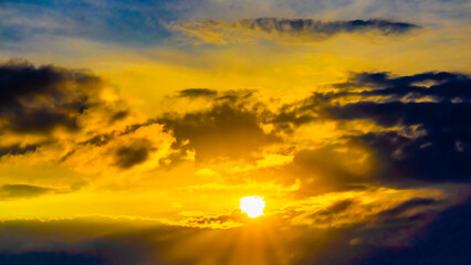 fiery orange and purple sky evening beauty and Clouds at sunset , dawn, the rays of the sun break through the clouds.