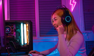 A Professional female pro gamer play online video games cyber sport and esport winner emotion. Young woman in tournament match worldwide in room colorful neon lights. - obrazy, fototapety, plakaty