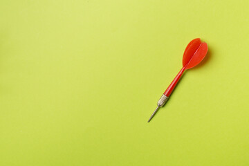 Red darts on color background, top view