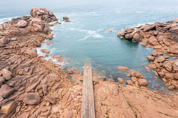 Red granite coast landscape in France.