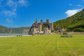 Huge Golubac fortress on hill behind beautiful green grass