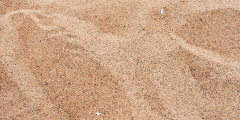 The texture of beautiful coarse sea sand with small pebbles and particles of shells. Yellow sand...