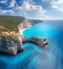 Aerial view of blue sea, mountain cape, sandy beach, sky with clouds at sunrset in summer. Porto Katsiki, Lefkada island, Greece. Beautiful top view of sea coast, rocks, azure water, green forest - obrazy, fototapety, plakaty