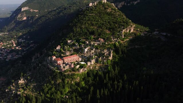 Drone shot of medieval old city of Mystras with Monastery of Pantanassa, Temple of Agia Sofia and uphill castle of Mystras, Sparta, Peloponnese, Greece