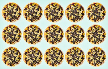 Food pattern of vegan pizza on pastel green background.