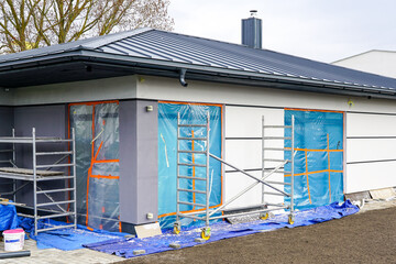 Unfinished modern precast single storey thermally insulated private house with gray metal roof