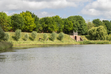 Naklejka premium 18th-century city gate and ramparts at the medieval Dutch fortified town of Brielle in South Holland.