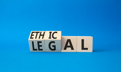 Obraz premium Ethical and Legal symbol. Turned wooden cubes with words Ethical and Legal. Beautiful blue background. Business and Ethical and Legal concept. Copy space