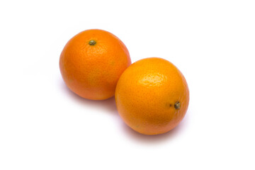 two tangerines lie on a white background
