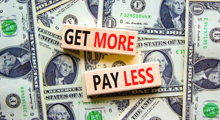 Get more pay less symbol. Concept words Get more pay less on wooden blocks on a beautiful...
