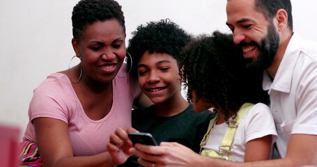 Family looking at cellphone device at home couch