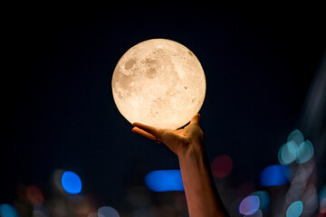 hand grabbing the moon at night © Ross