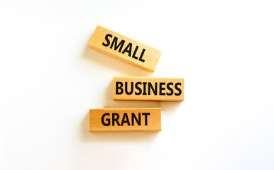 Small business grant symbol. Concept words Small business grant on wooden blocks on a beautiful white table white background. Business, finacial and small business grant concept.