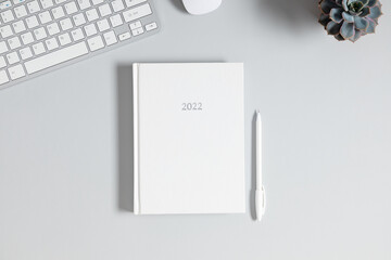 Gray office desk mockup, white book mockup, diary for 2022,, computer keyboard, plant. Flat lay,...