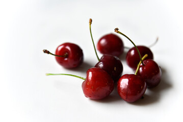 Obraz na płótnie Canvas Juicy red ripe cherries on a white background.