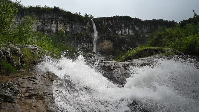 waterfall slowmotion, glacier 3000 les diablerets, water flowing down fast movement wide angle panoramic shot 120fps, 4k