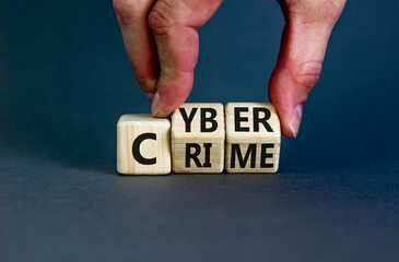 Cyber crime symbol. Concept words Cyber crime on wooden cubes. Businessman hand. Beautiful grey table grey background. Business and cyber crime concept. Copy space.