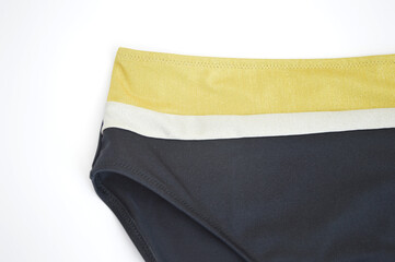 Black panties with a yellow stripe from a women's swimsuit, isolated on a white background. Beachwear for sports and recreation.