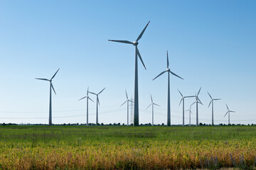 Wind power plants. Wind turbines powered by wind energy. Windmills in the fields. Environmentally friendly.