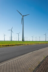 Wind power plants. Wind turbines powered by wind energy. Windmills in the fields. Environmentally friendly.