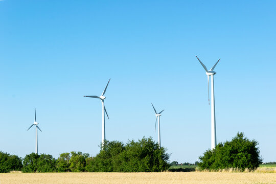 Wind Power Plants. Wind Turbines Powered By Wind Energy. Windmills In The Fields. Environmentally Friendly.