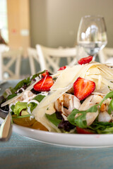 salad with shrimp, strawberries and hard cheese close-up